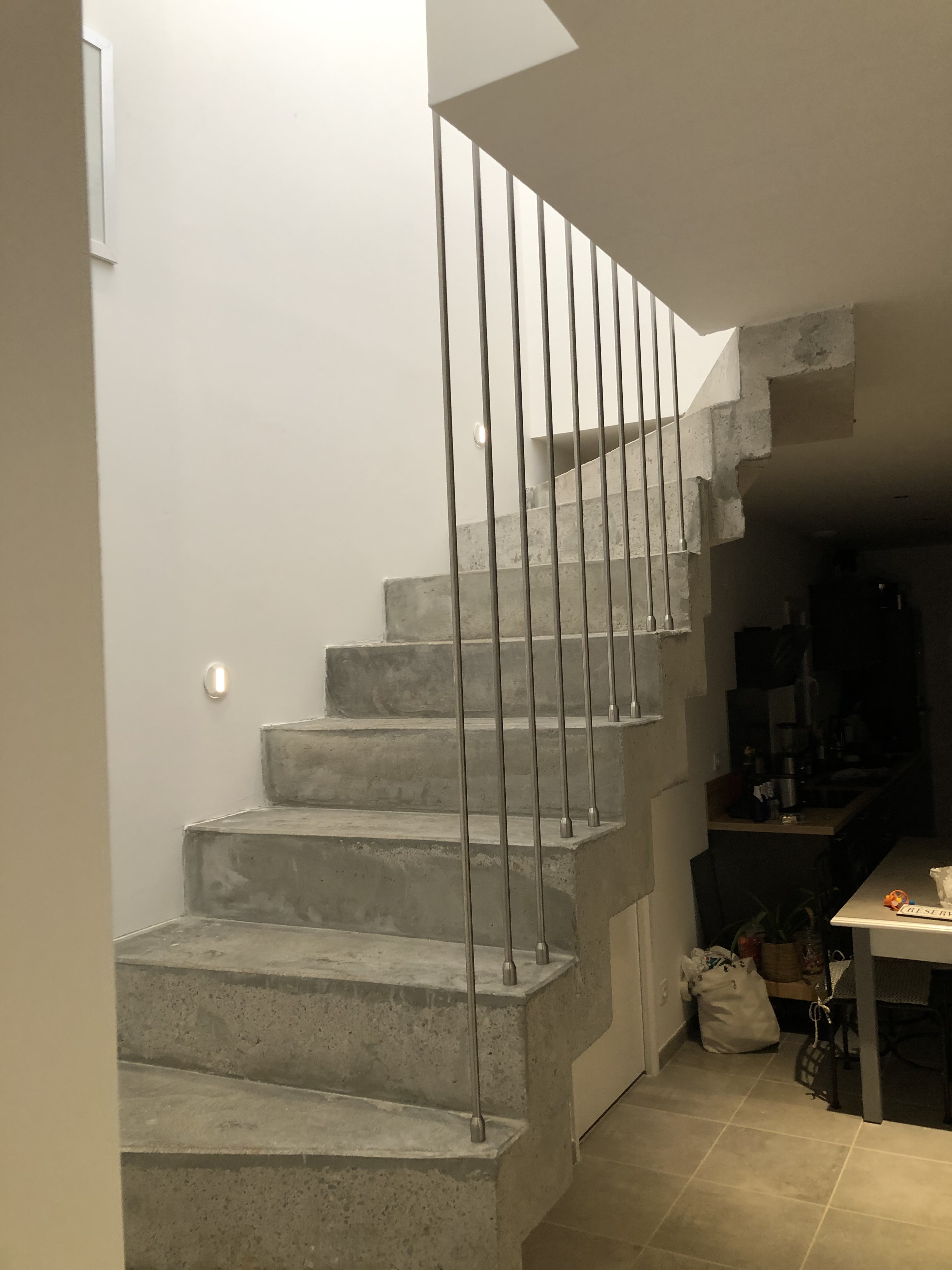 Escalier à crémaillère décoré de jolies tiges en inox, dans une maison individuelle à Saint-Jean-de-Védas, près de Vendargues en région Occitanie.