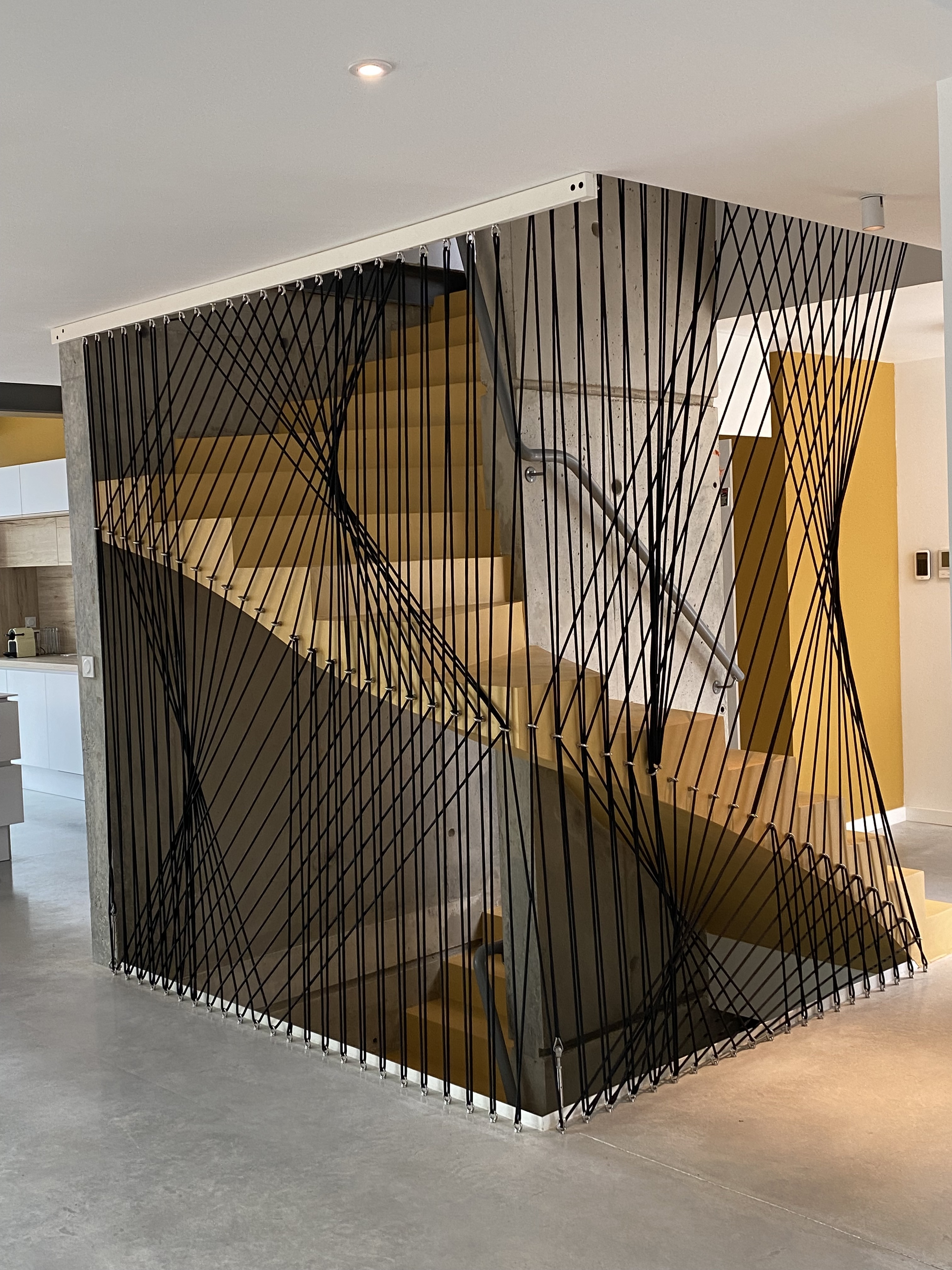 Elément décoratif majestueusement installé sur un escalier en béton ciré, dans un logement à côté de Beaulieu et Sussargues.